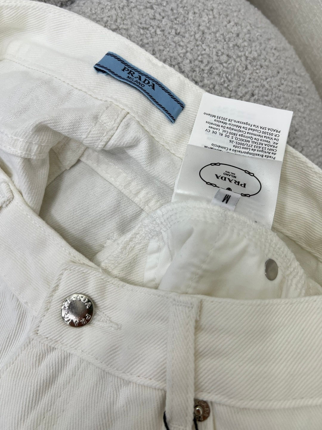 White jeans with classic triangle logo