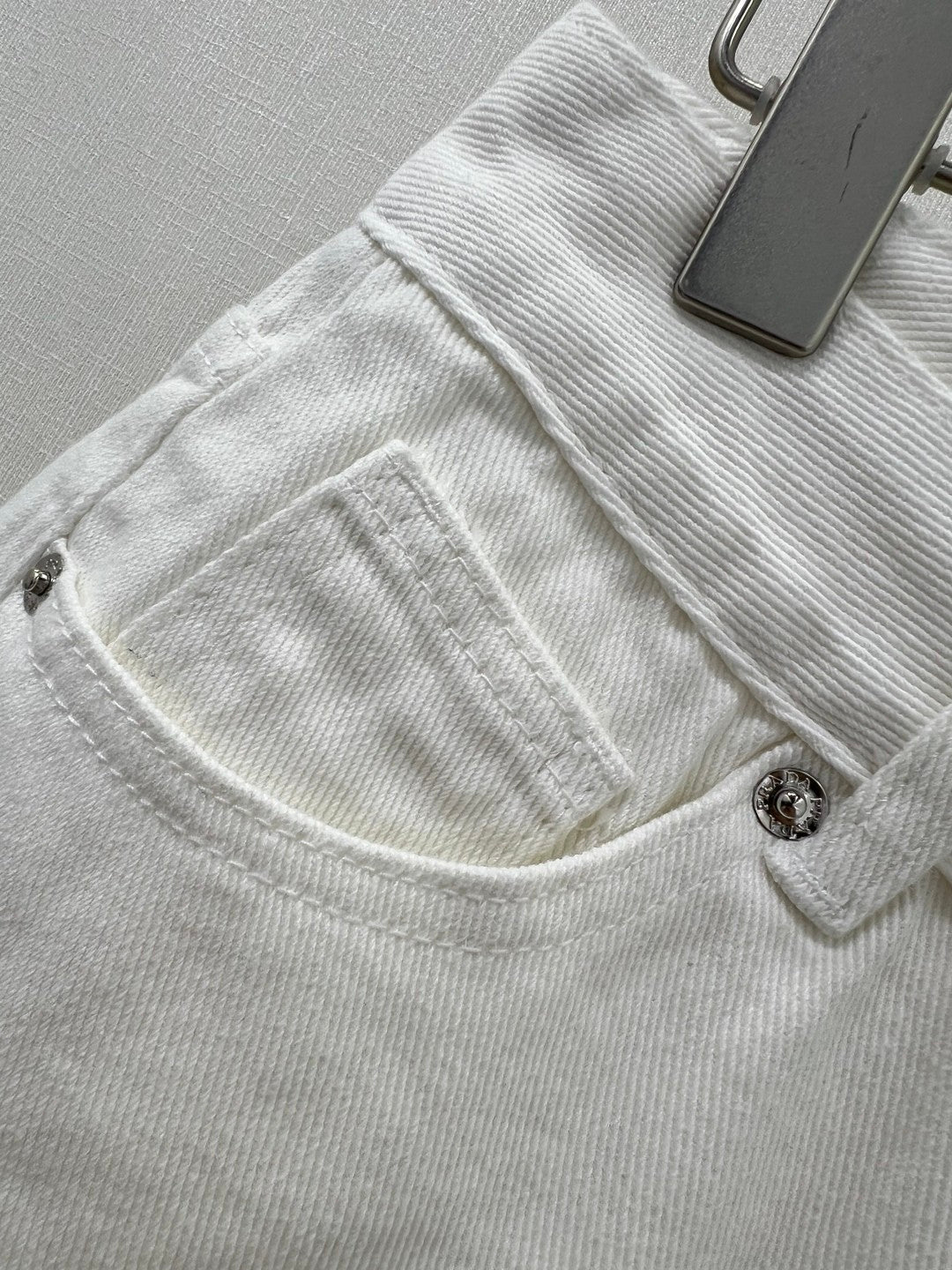 White jeans with classic triangle logo