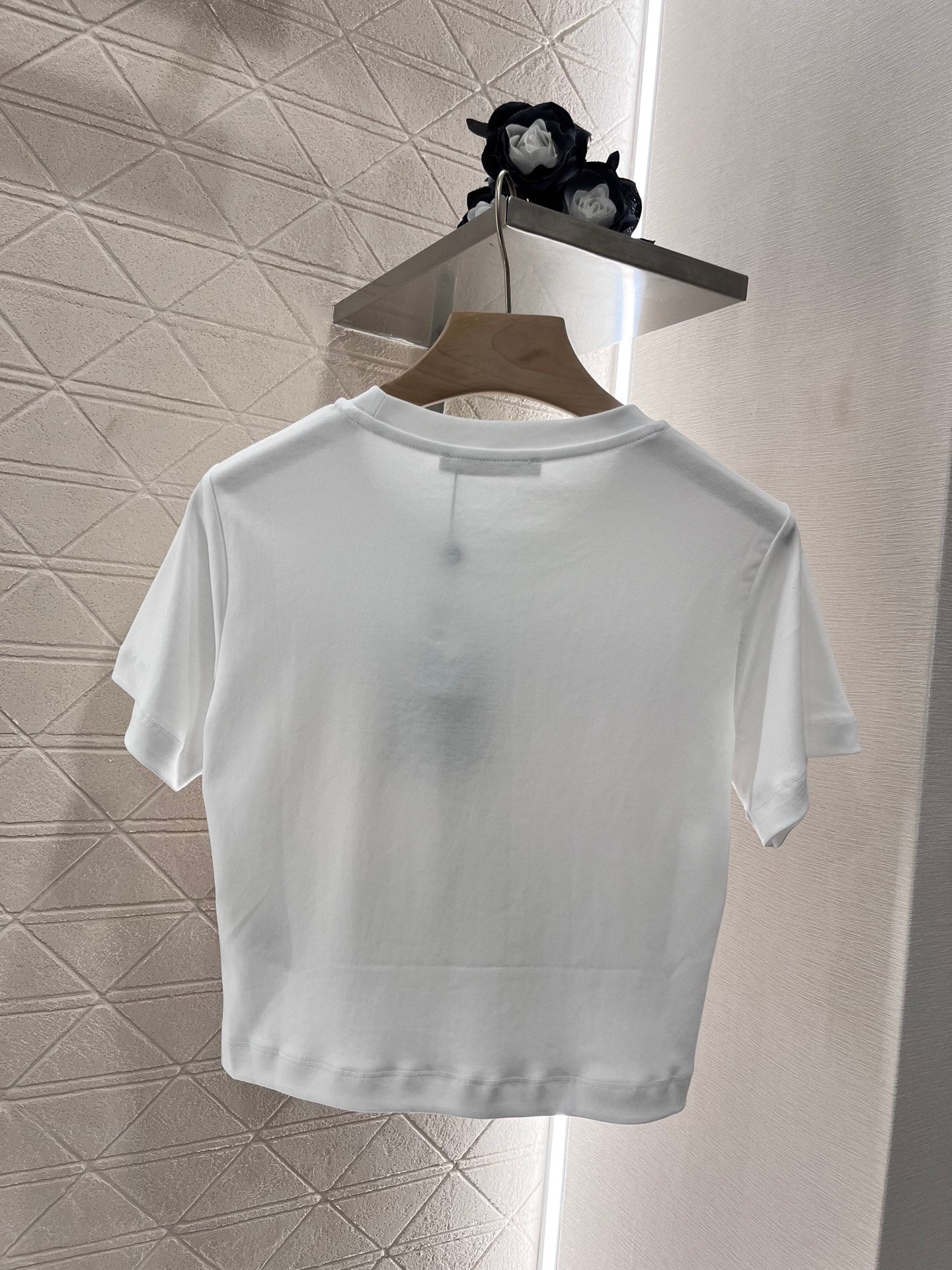 New product promotion. Walking on the street in a fashionable white T-shirt. Beautiful heart!